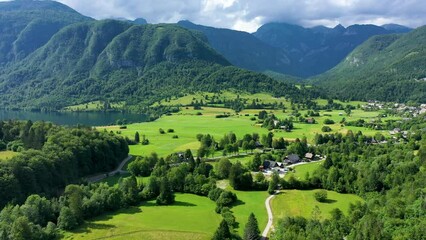 Aerial view of Bohinj lake in Julian Alps. Popular touristic destination in Slovenia. Bohinj Lake, Church of St John the Baptist. Triglav National Park, Julian Alps, Slovenia.