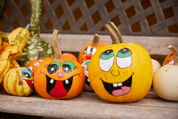 Closeup shot of orange and yellow Halloween and Thanksgiving pumpkins with cartoon stickers