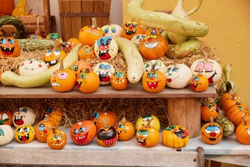 Closeup shot of orange Halloween and Thanksgiving pumpkins with stickers on them