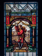 a stain glass window with a scene in it's center