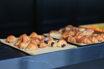 the trays are full of croissants on the counter