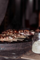 food cooking on skewers is being prepared and served