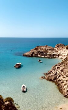 Vertical landscape scene of Cala salada beach with blue sky horizon sly in Ibiza, Spain
