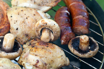 barbecue with delicious grilled meat and mushrooms