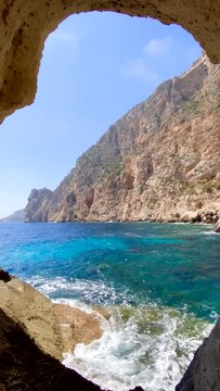 Marine cave on Es Vedra Island on the seaboard island of Ibiza, Spain, vertical shot