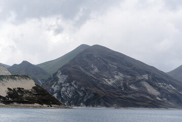 mountain lake with clear water and high mountains and clouds landscape