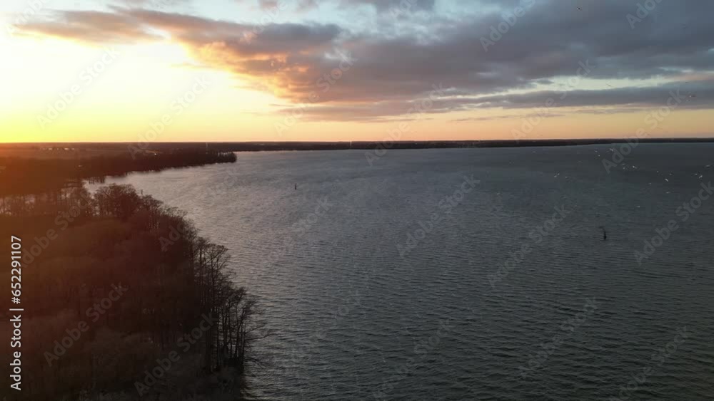 Wall mural Aerial view of breathtaking sunset with sea and flying birds around