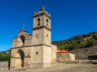 Fototapeta na wymiar Facade of the Romanesque Church of Santa María de Barrô (12th century). The bell tower was built in the 19th century. Duero valley, Resende, Portugal.