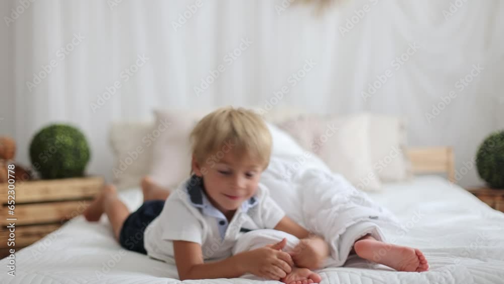 Wall mural happy positive children, tickling on the feet, having fun together, boy and girl at home having wond