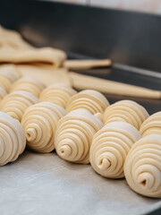 Raw croissants in production in a bakery close-up