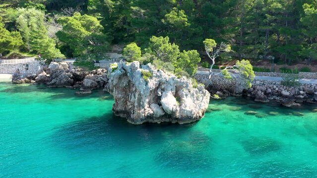 Kamen Brela symbol of the city of Brela on Adriatic coast of Dalmatia, Croatia. Kamen Brela, tiny famous island in Brela, Makarska Riviera, Dalmatia, Croatia.