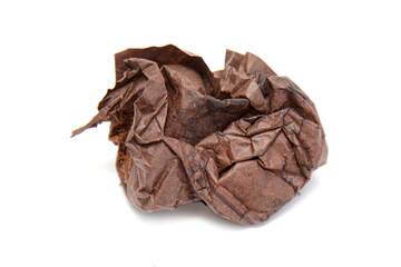 square piece of old crumpled chocolate-colored paper on a white background