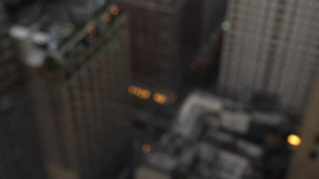 Rainy day in New York city. 4k close up video with selective focus on rain water drops on window and the skyscrapers under clouds in background.