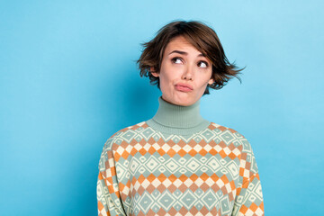 Portrait of minded doubtful person look interested empty space contemplate isolated on blue color...
