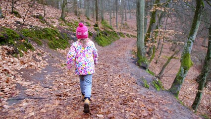 Young Girl Running in Autumn Forest on Fallen Leaves Flycam Tracking Shot