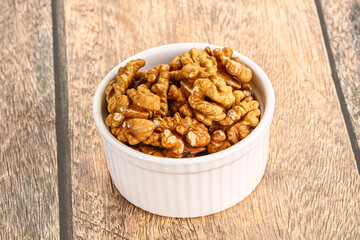 Cracked unshelled walnut in the bowl