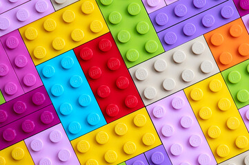 Naklejka premium Lots of colorful Lego pieces. Lego background.