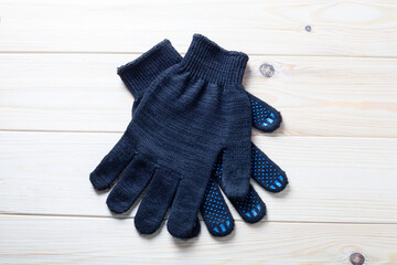 pair of black working gloves with rubber dots.