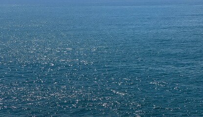 Blue sea water shiny surface background.