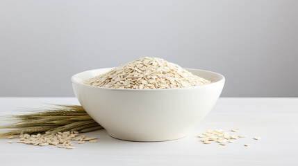 Oatmeal dry cereal in a white bowl, natural oat cereal, a healthy breakfast. Copy space for text, flat lay. 