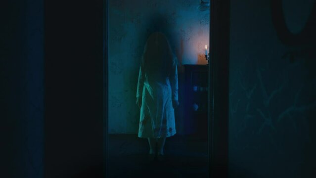 Ghost of woman in nightgown with long messy hair standing in room, glitch effect