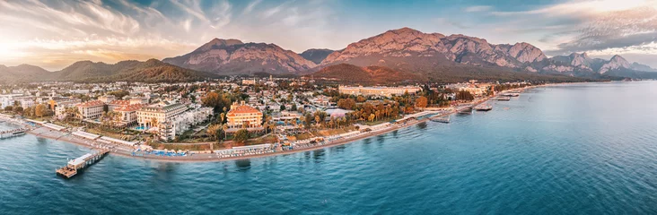 Poster beauty of Kemer from a new perspective with breathtaking aerial view, showcasing a stunning panorama of hotels nestled amidst the scenic mountain landscape. © EdNurg