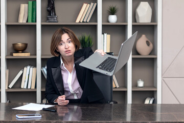 Fototapeta na wymiar Tired frustrated and overworked business woman sitting in the office and thinking about problems in business 