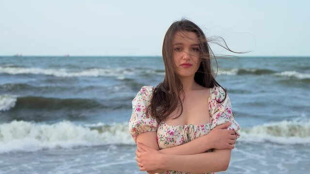 Close up upset thoughtful woman looking at camera at sea beach. Portrait of sad female face. Fashion model posing outdoor. Relax leisure activity, active lifestyle, cheerful confident attractive girl