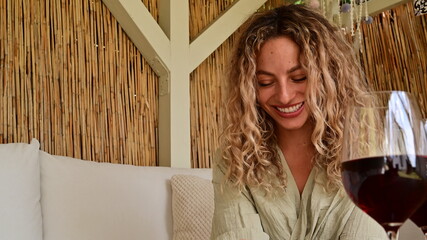 Laughing beautiful young woman with blond curly hair in summer vacation. 
