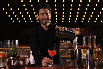 Bartender preparing fresh alcoholic cocktail in bar