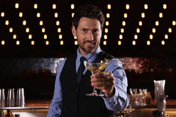 Bartender with fresh alcoholic cocktail in bar