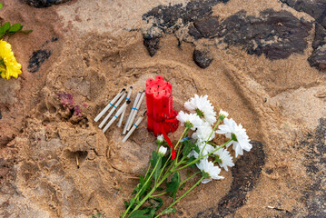 White flowers with candles on the beach sand. Gift for Iemanja the queen of the sea.