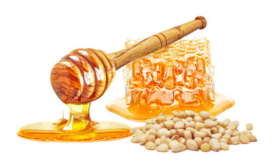 dripping honey, honeycomb and pine nuts isolated on white background