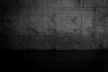 Grungy dark concrete wall and wet floor