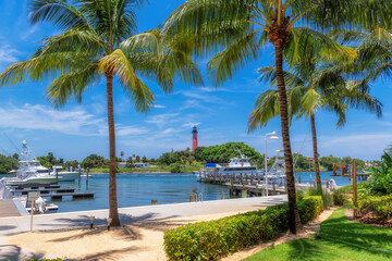 Jupiter lighthouse and harbor at sunny summer day and palm trees, West Palm Beach, Florida