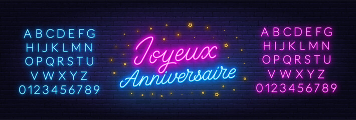Joyeux Anniversaire neon lettering on brick wall background. Happy Birthday in French - obrazy, fototapety, plakaty