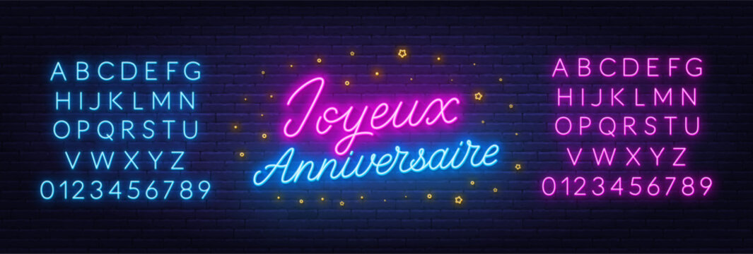 Joyeux Anniversaire neon lettering on brick wall background. Happy Birthday in French