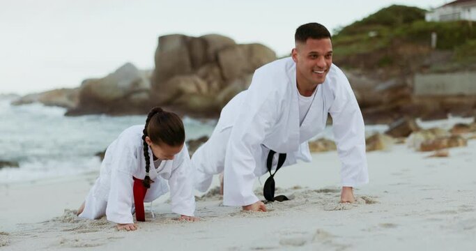 Beach, karate exercise or child learning martial arts fighting or taekwondo in fitness workout or push ups. Challenge, man or teacher teaching a kid, girl or student in training for power at sea