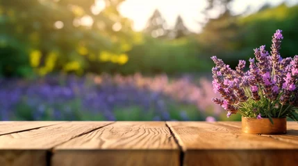 Fototapeten Lavender bouquet on the wooden table at organic lavender farm background. © Sunday Cat Studio