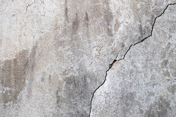 Close-up of Cracked concrete wall texture, Cement background not painted in vintage style for graphic design or retro wallpaper,texture crack in concrete wall