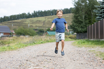 happy boy running through the streets of the village, vacation