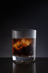 Glass of cold cocktail with cola, whiskey or rum