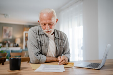 senior caucasian man open mail letter sign contract document at home - Powered by Adobe