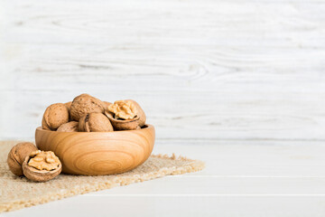 Fresh healthy walnuts in bowl on colored table background. Top view Healthy eating bertholletia concept. Super foods