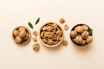 Walnut kernel halves, in a wooden bowl. Close-up, from above on colored background. Healthy eating Walnut concept. Super foods with copy space