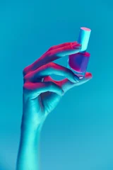 Foto op Plexiglas Well-kept female hand with nude, natural nails, manicure holding nail polish, gel isolated over blue background in neon light. Concept of hand care, cosmetics and cosmetology, beauty. Poster, ad © master1305