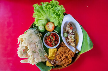 Top view of Sundanese Nasi Liwet main course, a traditional culinary from West Java, Indonesia.