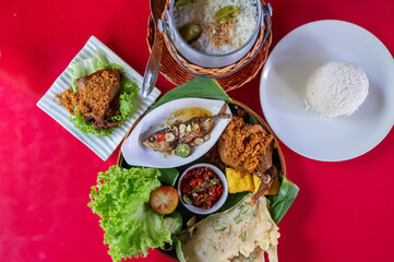 Top view of Sundanese Nasi Liwet main course, a traditional culinary from West Java, Indonesia.