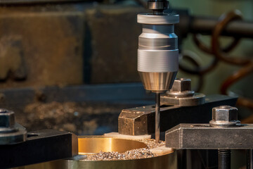 The drilling process on NC milling machine with brass material.