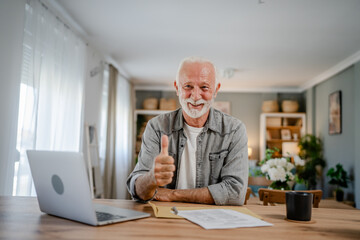 senior caucasian man open mail letter or document envelope at home